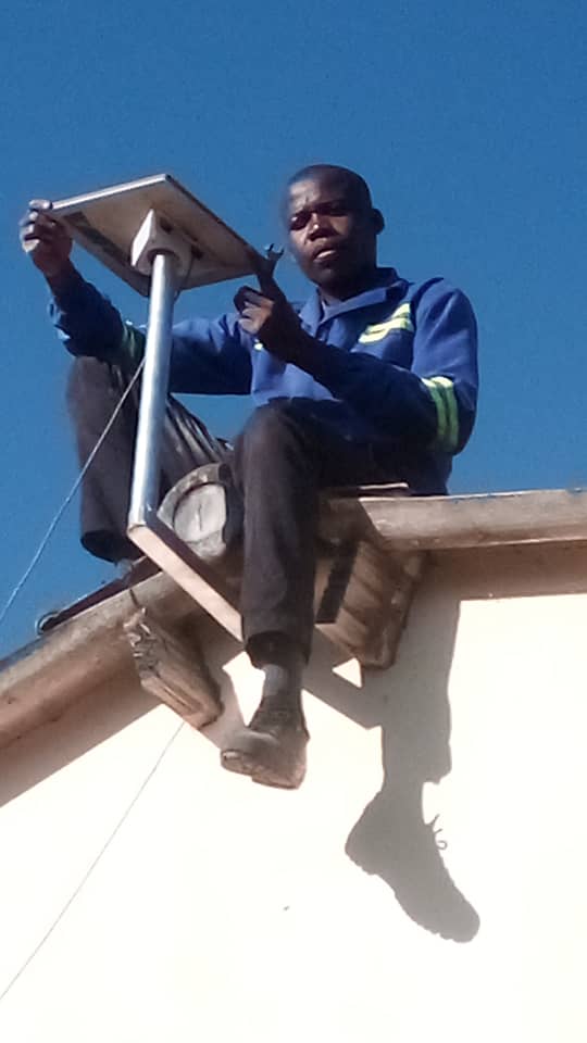 Technician installing Starlink dish on rooftop