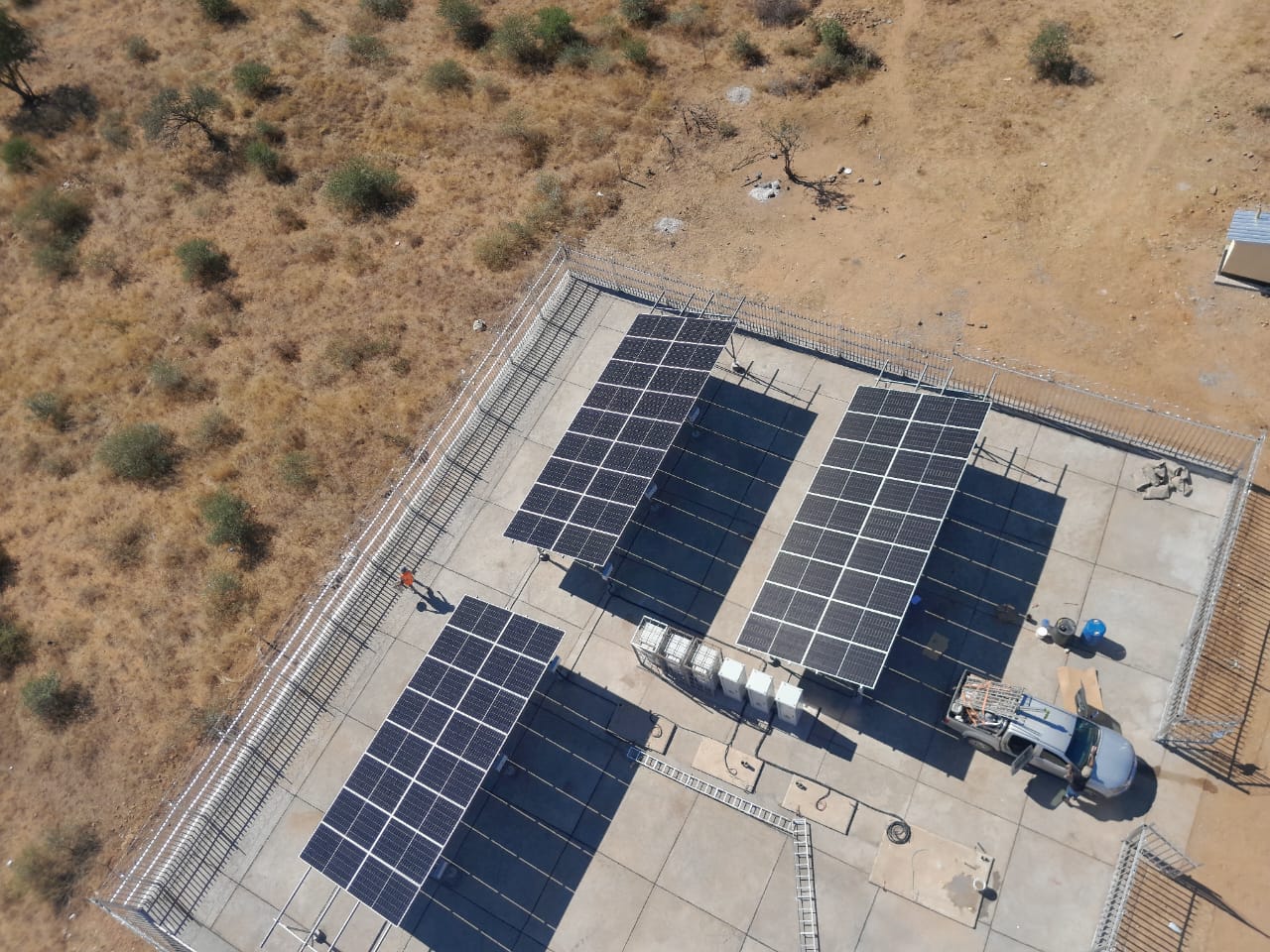 Aerial view of large ground-mounted solar array installation