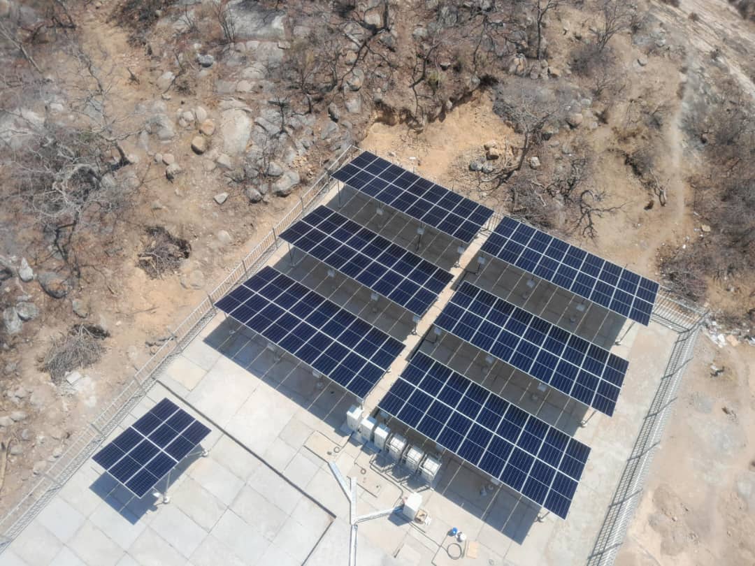 Large ground-mounted solar array in rocky terrain
