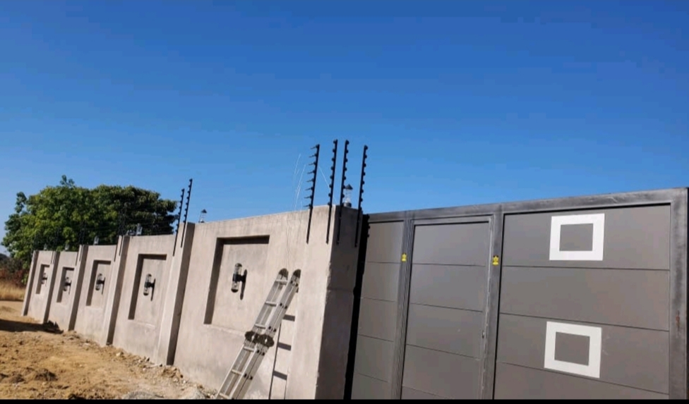 Electric fencing along concrete perimeter wall