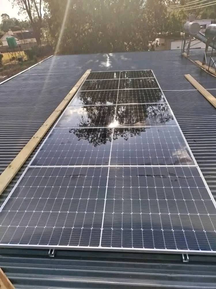 Rooftop solar panel array on corrugated roof