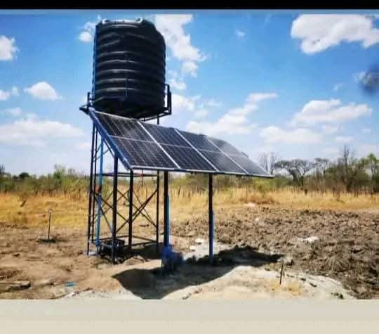Solar-powered water pump with elevated storage tank